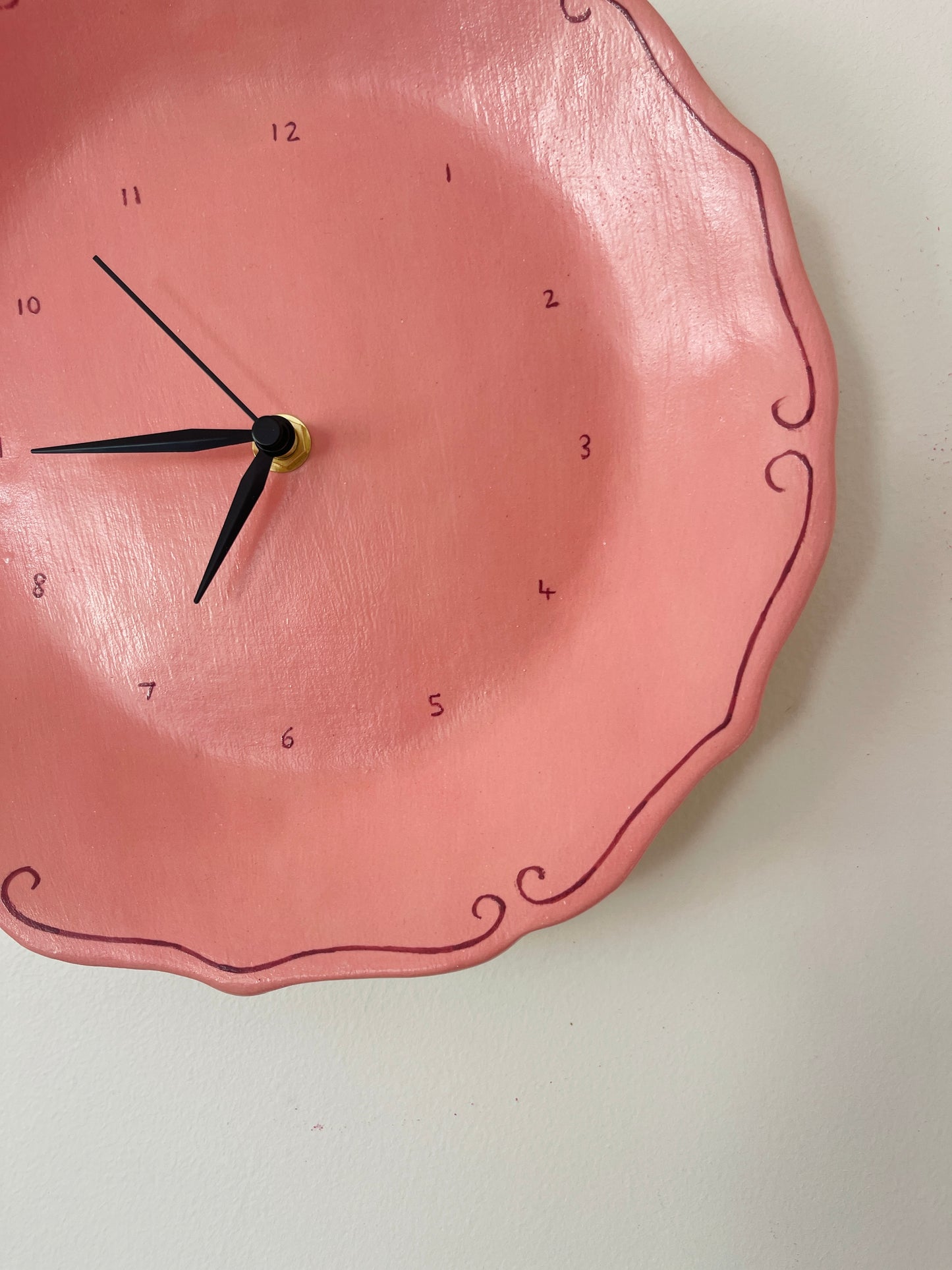 Pink ceramic clock with curlicues