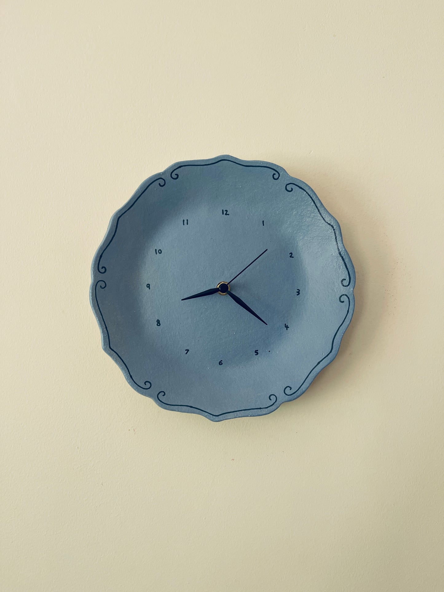 Blue ceramic clock with curlicues