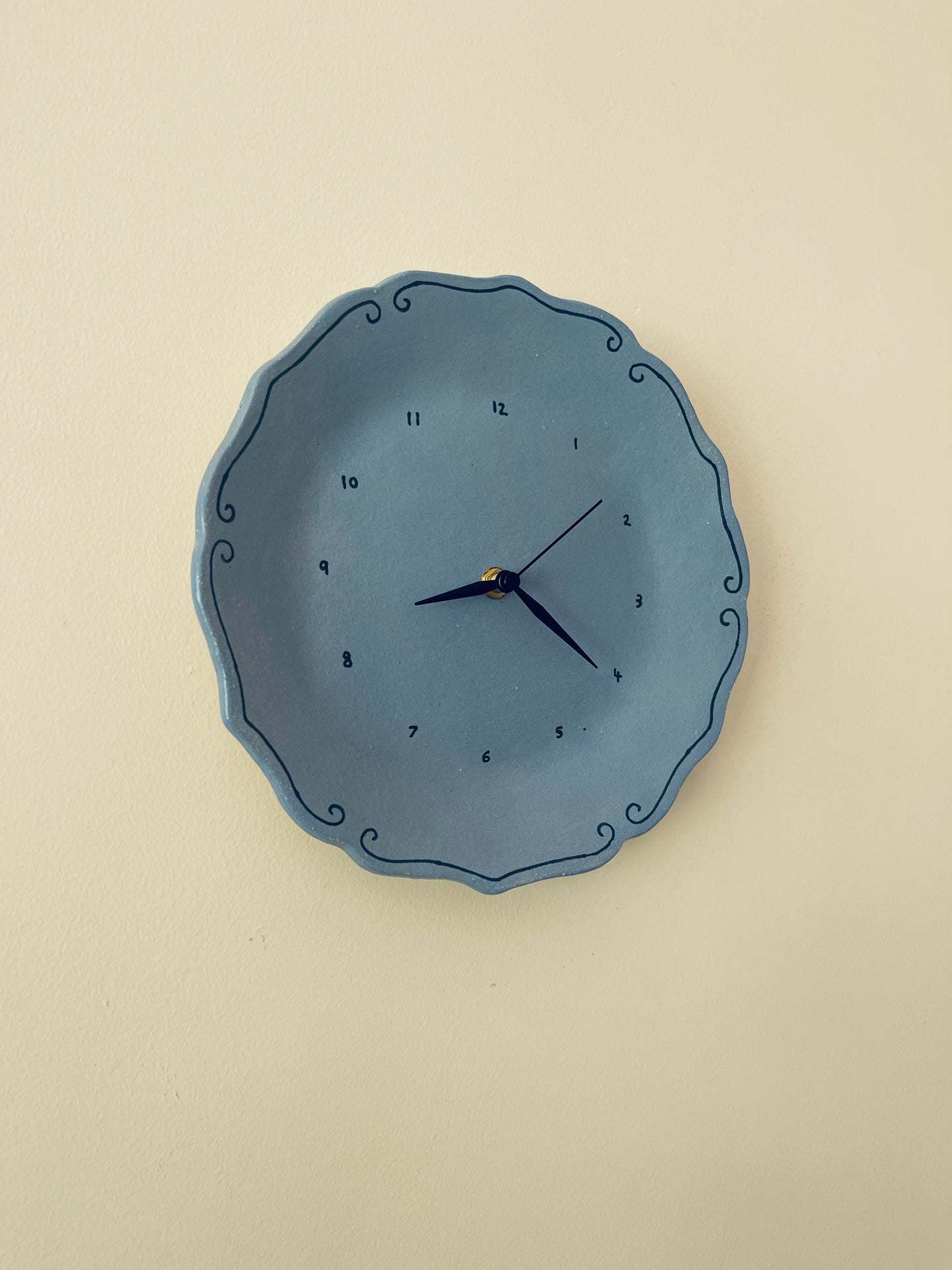 Blue ceramic clock with curlicues