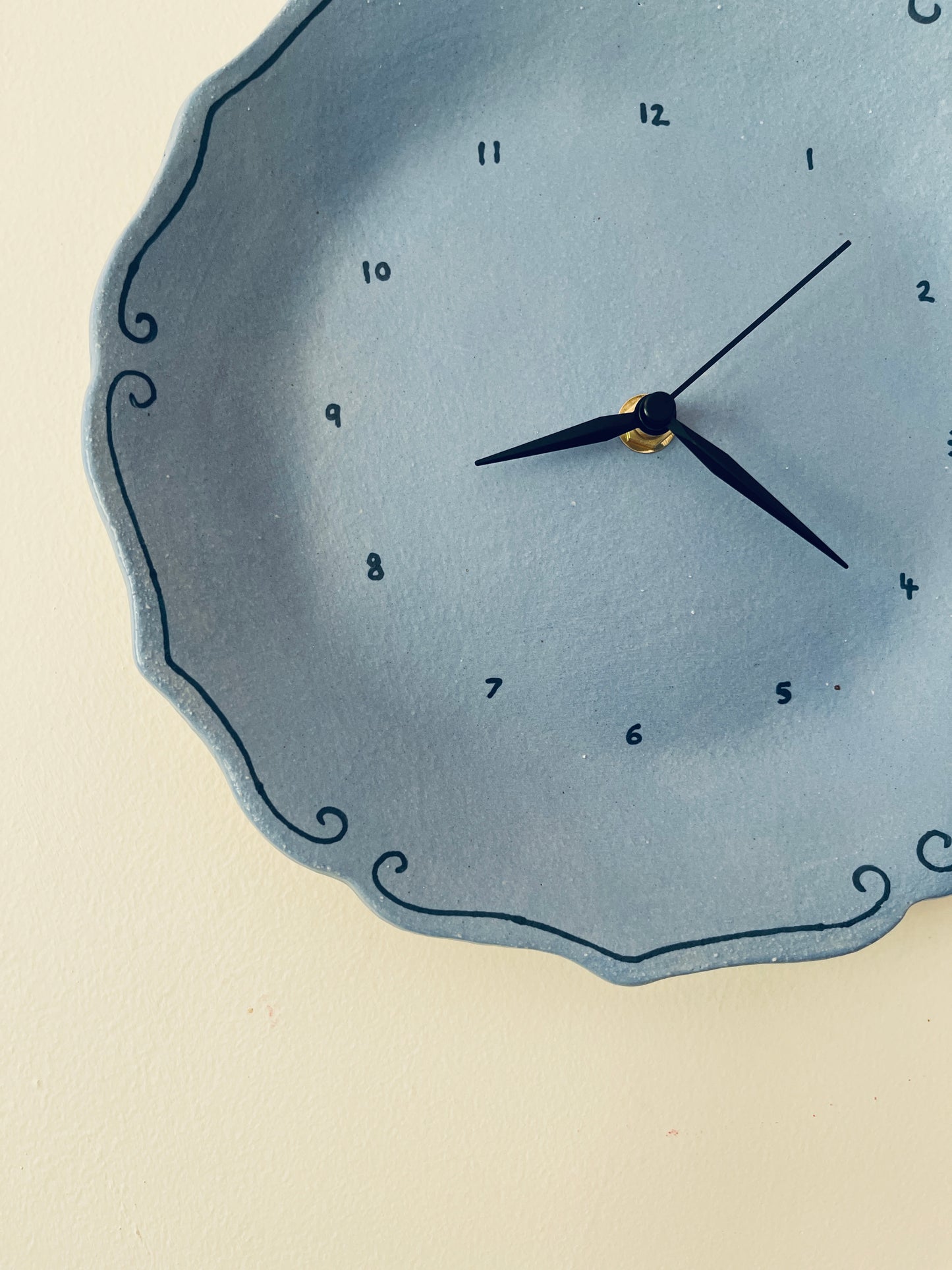 Blue ceramic clock with curlicues