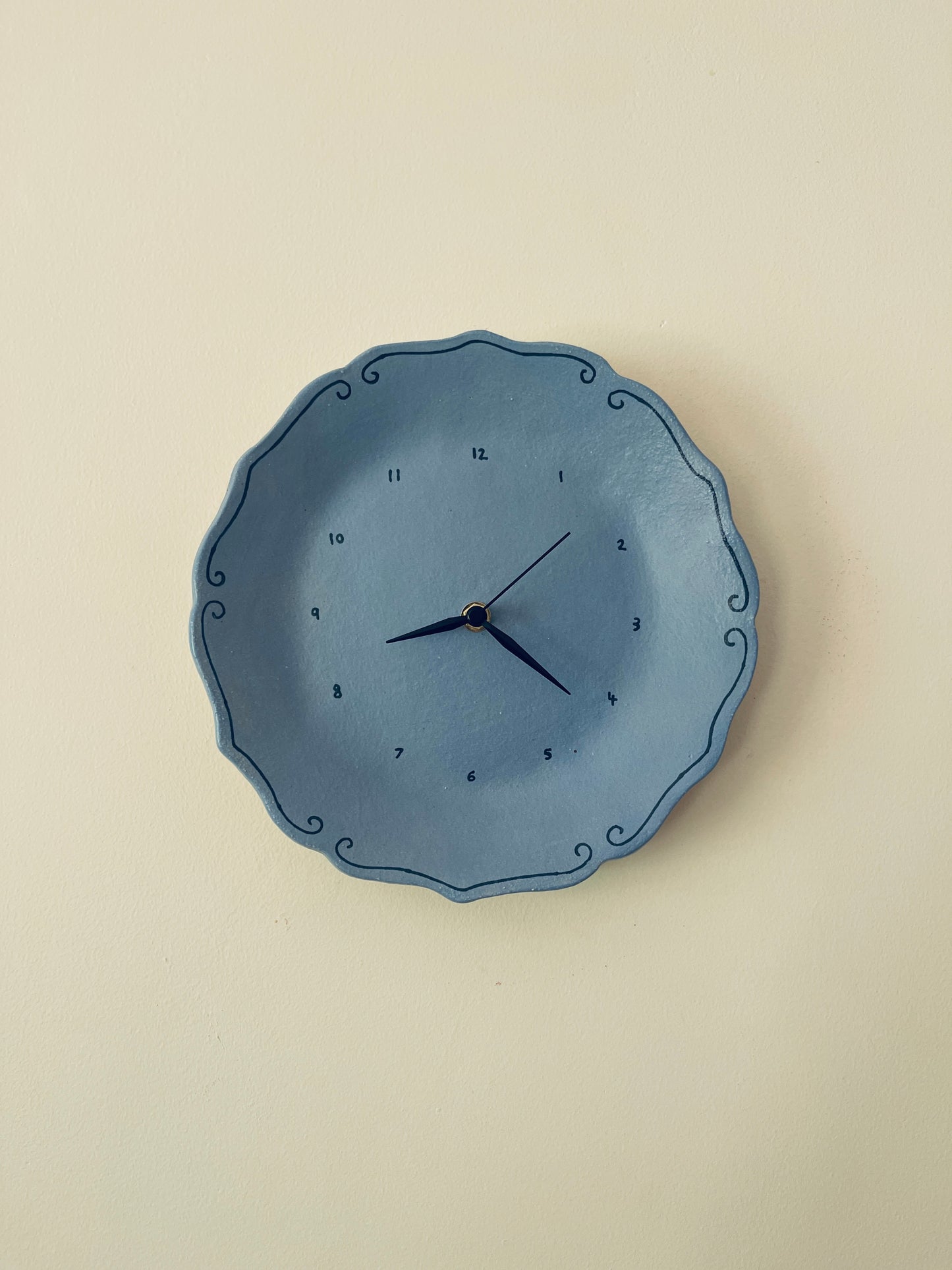 Blue ceramic clock with curlicues
