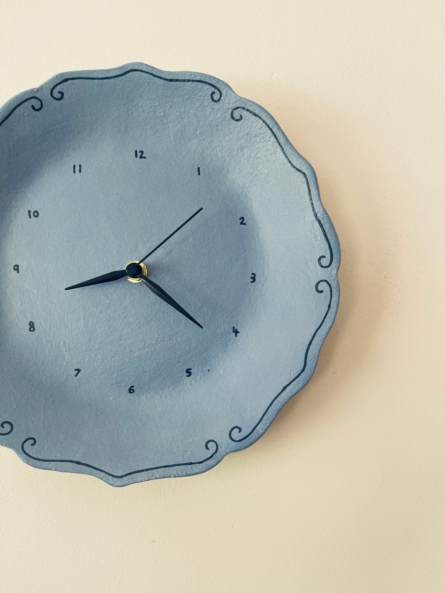 Blue ceramic clock with curlicues