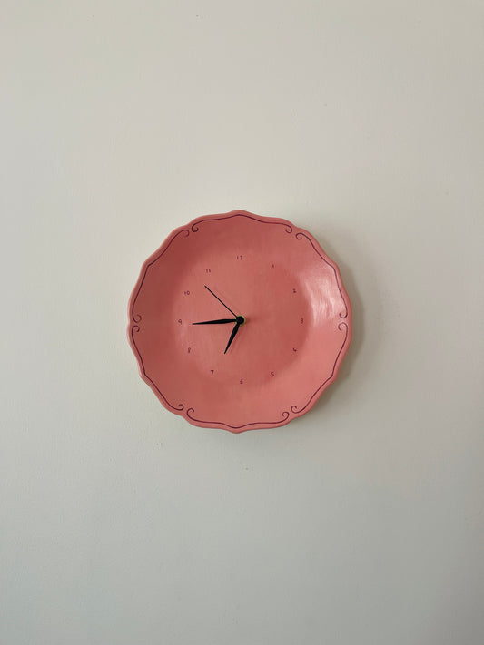 Pink ceramic clock with curlicues