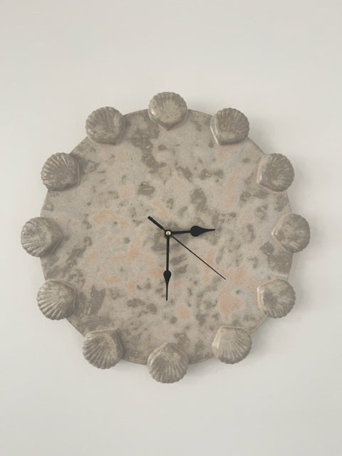 Ceramic clock with shell guides